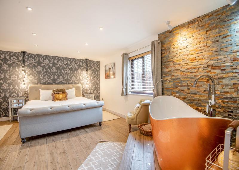 Luxurious bedroom with free standing bath